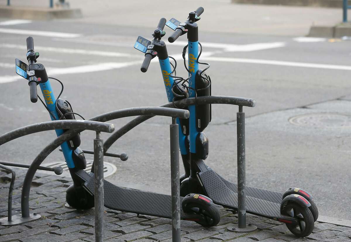 Skip e-scooters are parked on King Street in San Francisco, Calif. on Tuesday, March 19, 2019. They were harder to locate on Monday morning. 
