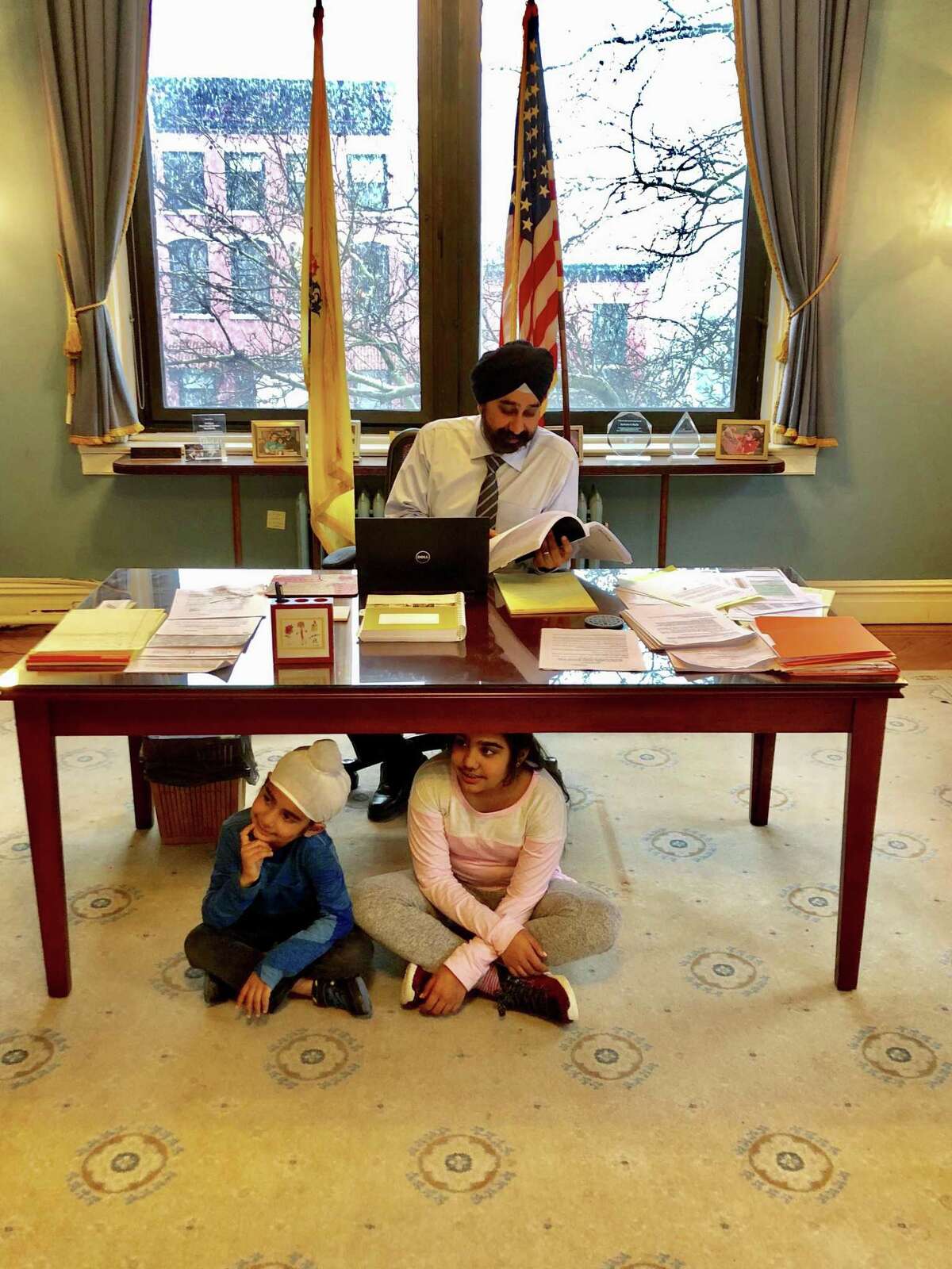 Hoboken Mayor Ravinder Bhalla is at work with his two children, 11-year old daughter Arza Kaur and 7-year old son Shabegh Singh, nearby.