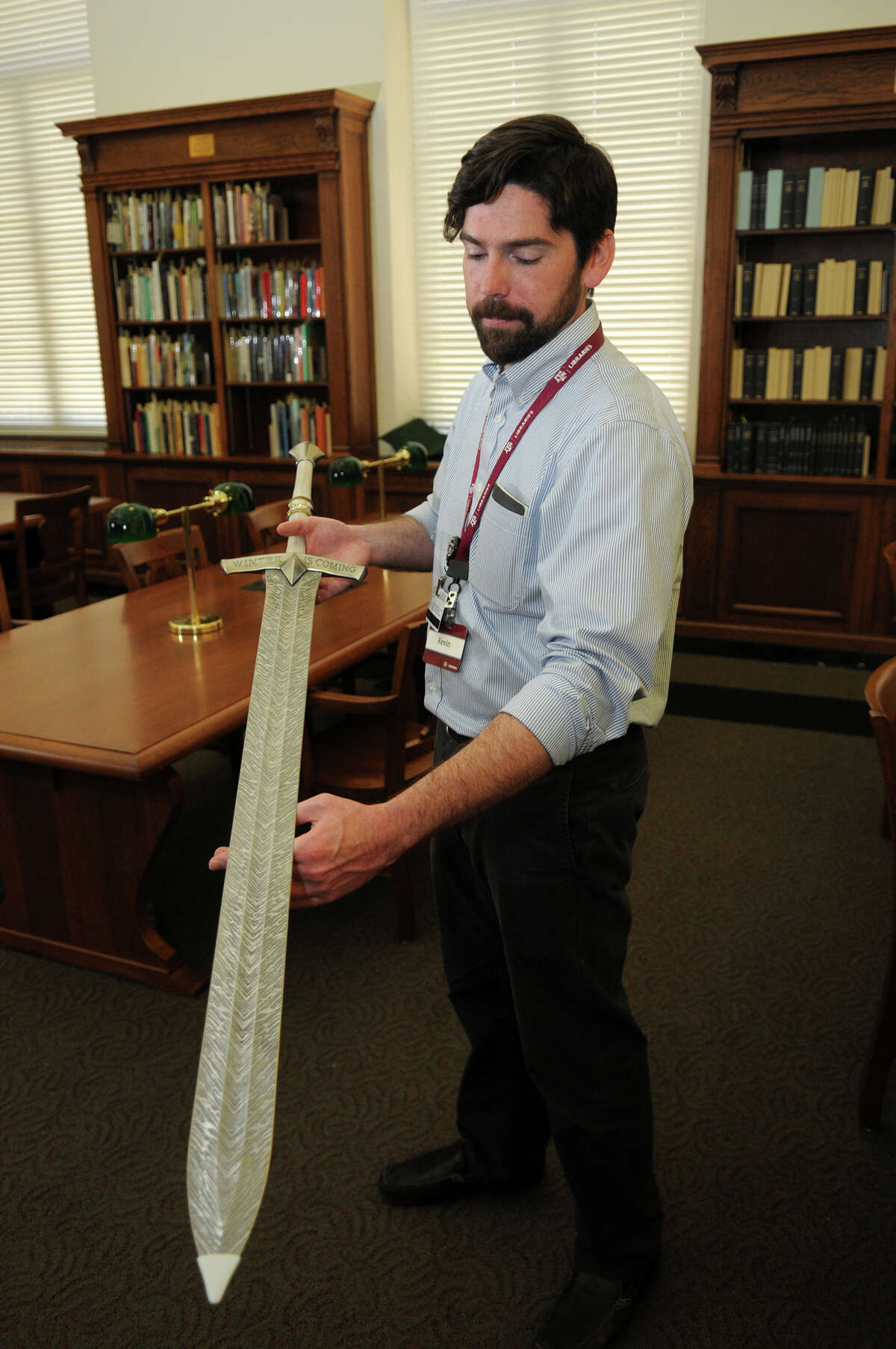 Kevin O'Sullivan, Instructional Assistant Professor and Outreach and Public Service Curator at the Cushing Memorial Library & Archives on the campus of Texas A&M University, shows off a replica of Ice, the ancestral greatsword of House Stark, carried by Ned until his arrest and used to execute him, produced by Valyrian Steel.