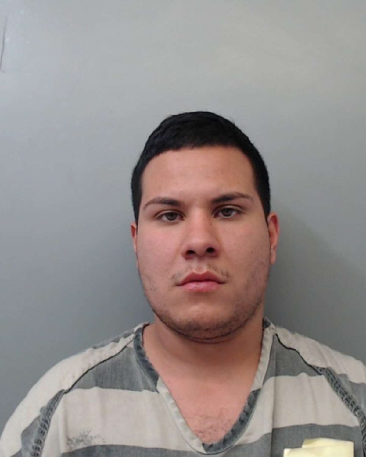 Alfredo Menchaca, 24, was charged with theft and evading arrest.