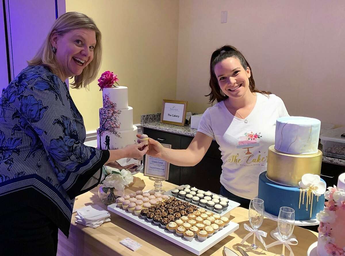 Seen here at a recent fundraiser, Pacific House supporter Laura Roberts of Fairfield enjoys a cupcake from Natalie Rose, owner of The Cakery in Stamford. Pacific House, while not located in Greenwich, will get block grant funding from the town.