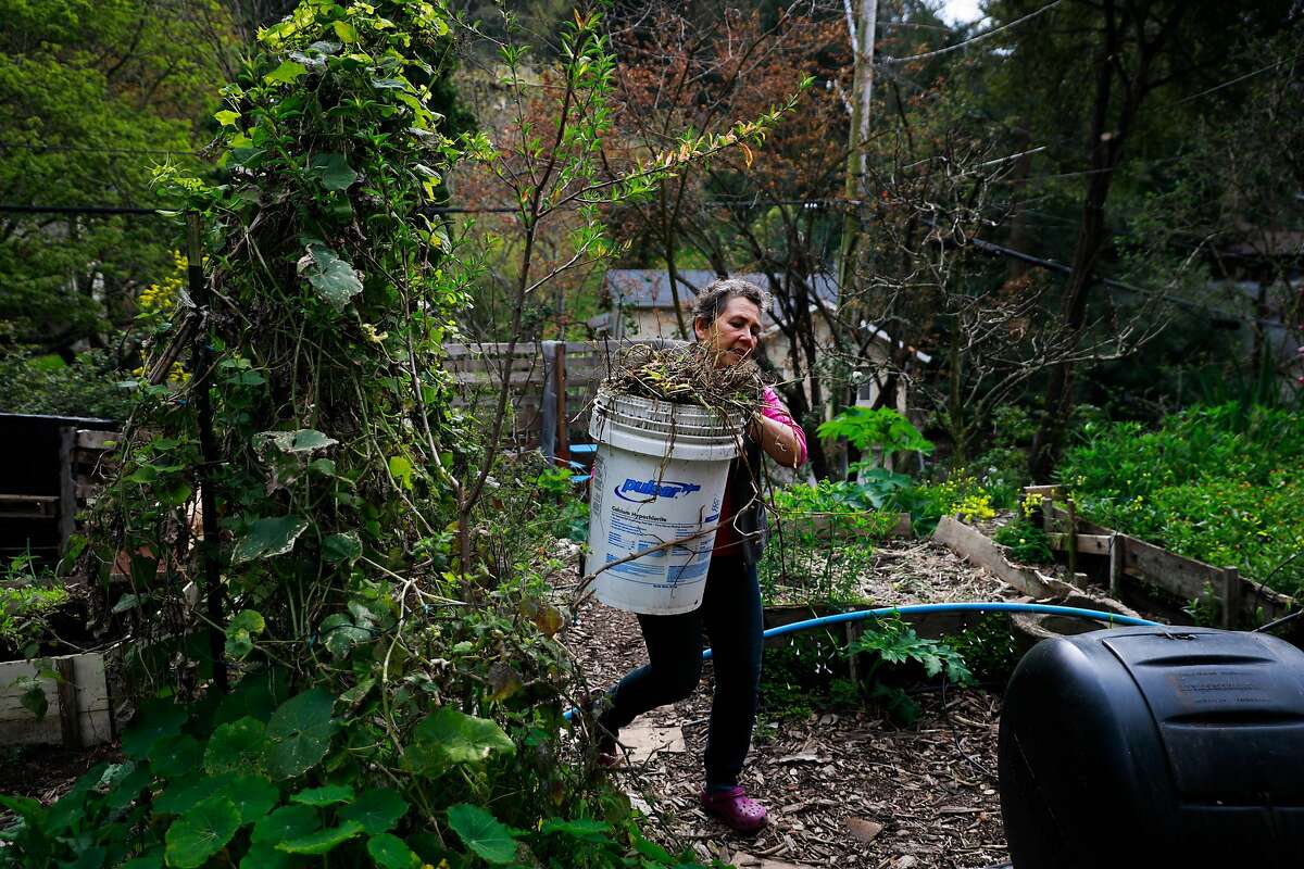 Jeannie McKenzie gardens on her homestead in Oakland, California, on Monday, April 1, 2019.