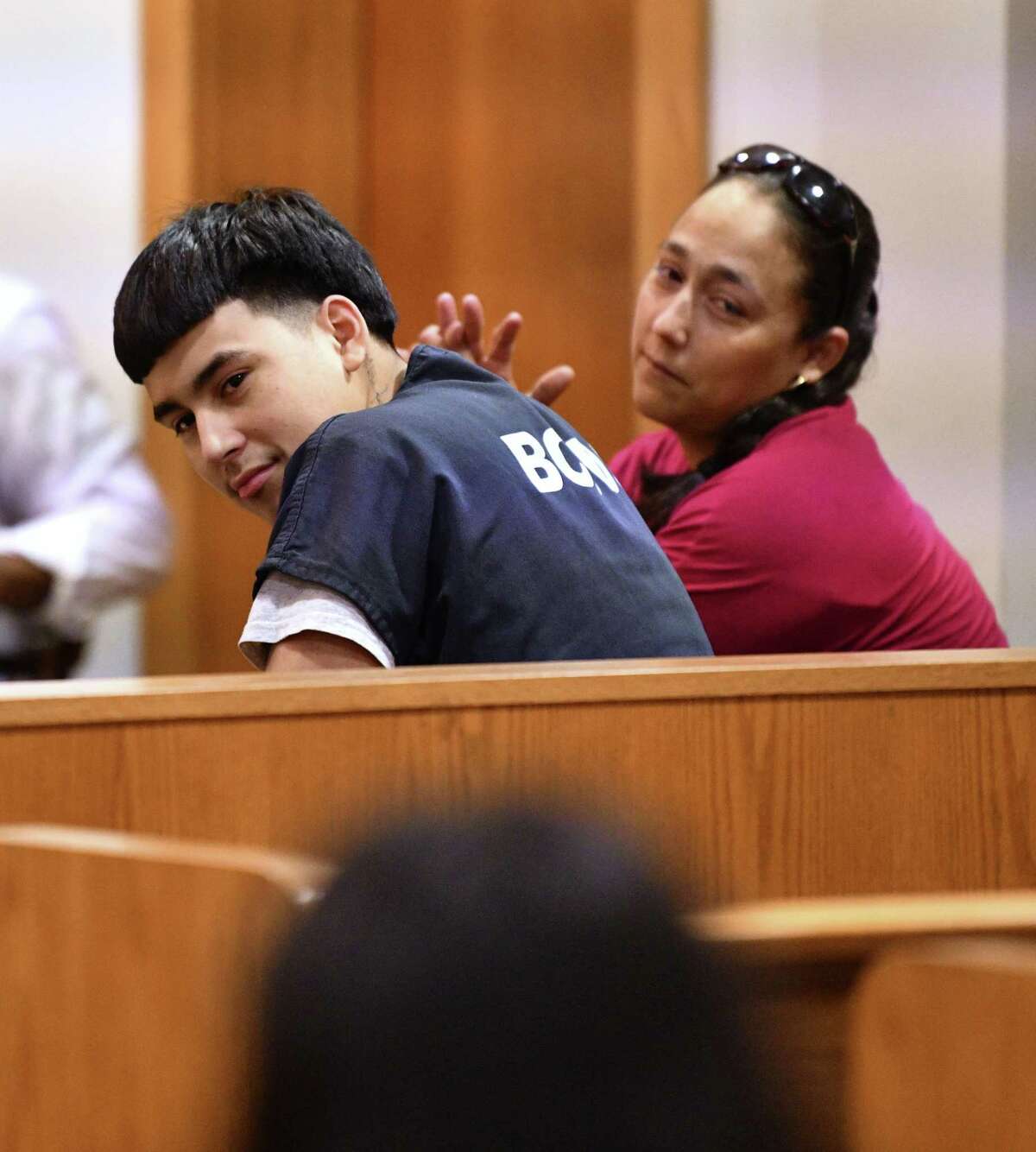 Raul Cervera looks at friends and family as hesits with his mother, Rosenda Armendariz, during a hearing at which he was certified as an adult to stand trial in a capital murder case. Cervera is charged with shooting Abram Garcia IV to death in 2018. Judge Lisa K. Jarrett presided over the hearing on Tuesday, April 16, 2019.