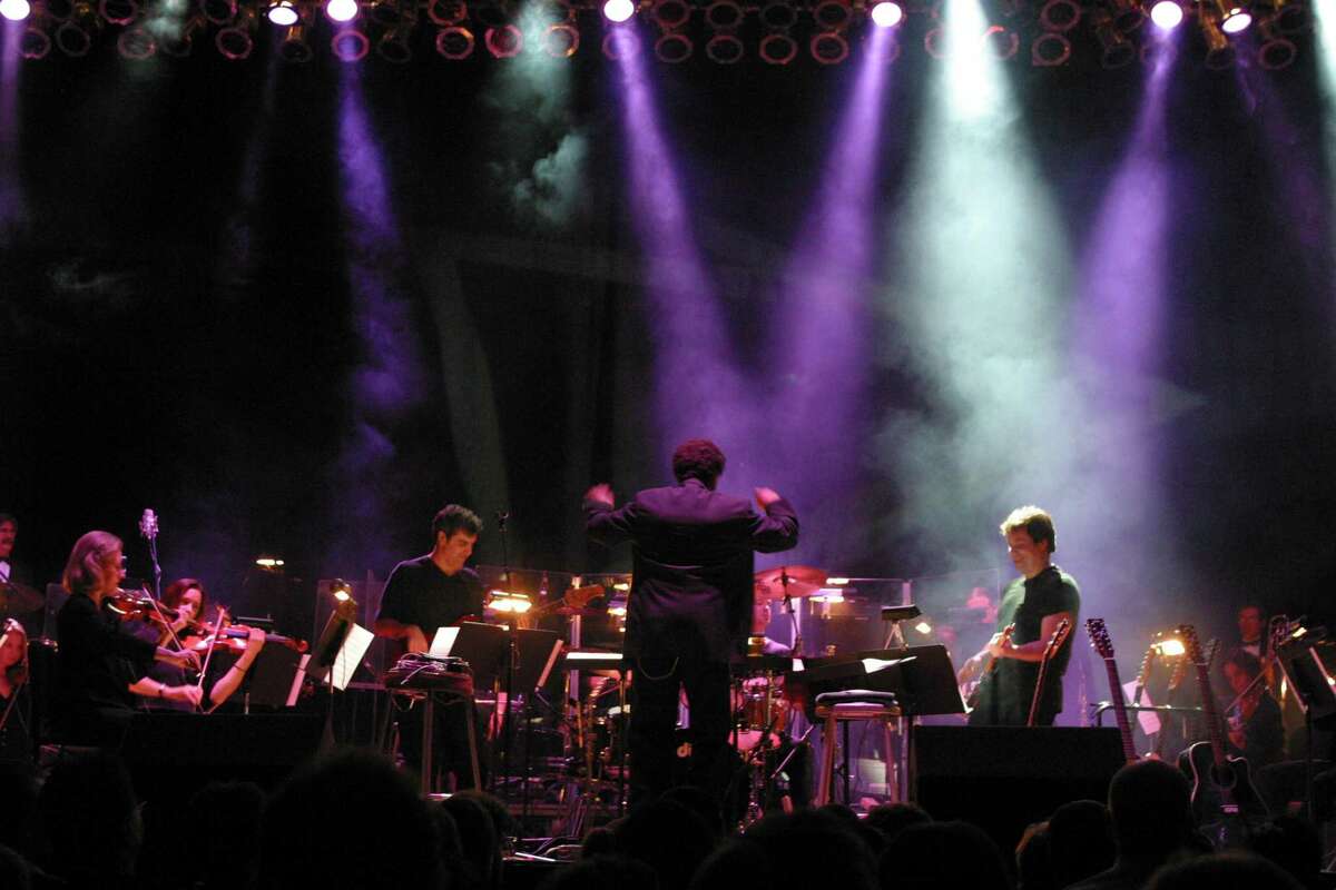 Brent Havens conducting a symphony during a concert devoted to the music of Led Zeppelin