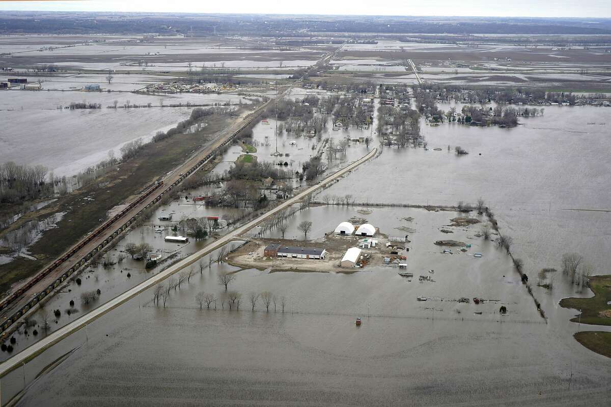 In this Friday, April 12, 2019 photo, the flooded town of Pacific Junction, Iowa, is seen from above. This spring’s massive flooding along the Missouri River unearthed bitter criticism of the federal agency that manages the river while devastating communities and causing more than $3 billion in damage. The flooding and the U.S. Army Corps of Engineers’ actions will be the focus of a U.S. Senate hearing in western Iowa on Wednesday, April 17, 2019, and critics will demand the agency make flood control its top priority. (AP Photo/Nati Harnik)