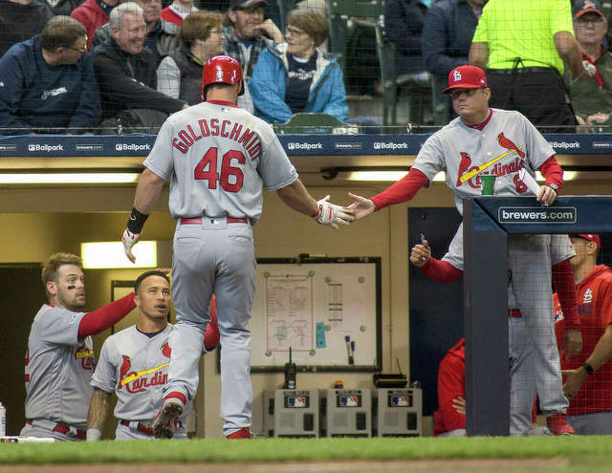 The Cardinals’ Paul Goldschmidt is congratulated by manager Mike Schildt scoring off a RBI single by Paul DeJong in Wednesday’s win in Milwaukee.