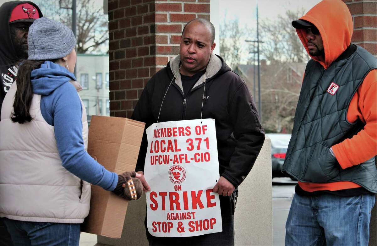 Kevin Hall, center, of New Haven, pickets Monday at the city Stop & Shop store where he’s worked for five years.