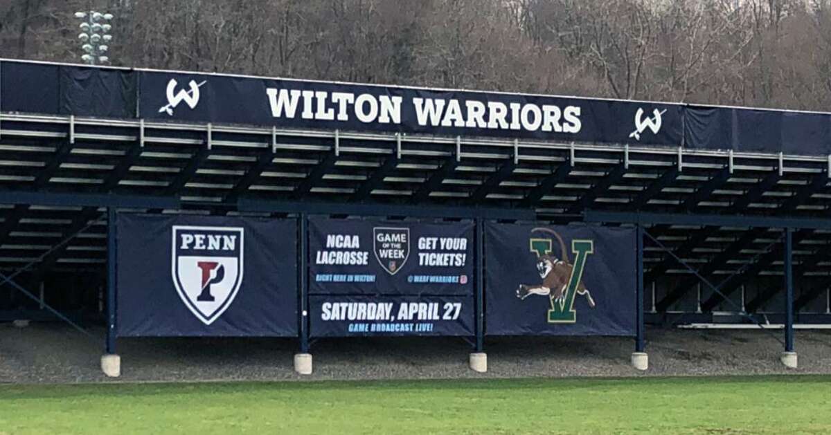 A sign promoting an NCAA men’s lacrosse game between Penn and Vermont at Wilton High School’s Fujitani Field.