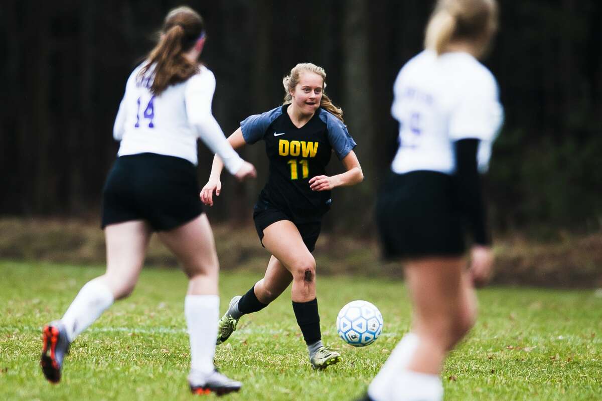 Dow's Jordan Danna dribbles down the field during a game against Bay City Central on Wednesday, April 17, 2019 at H. H. Dow High School. (Katy Kildee/kkildee@mdn.net)