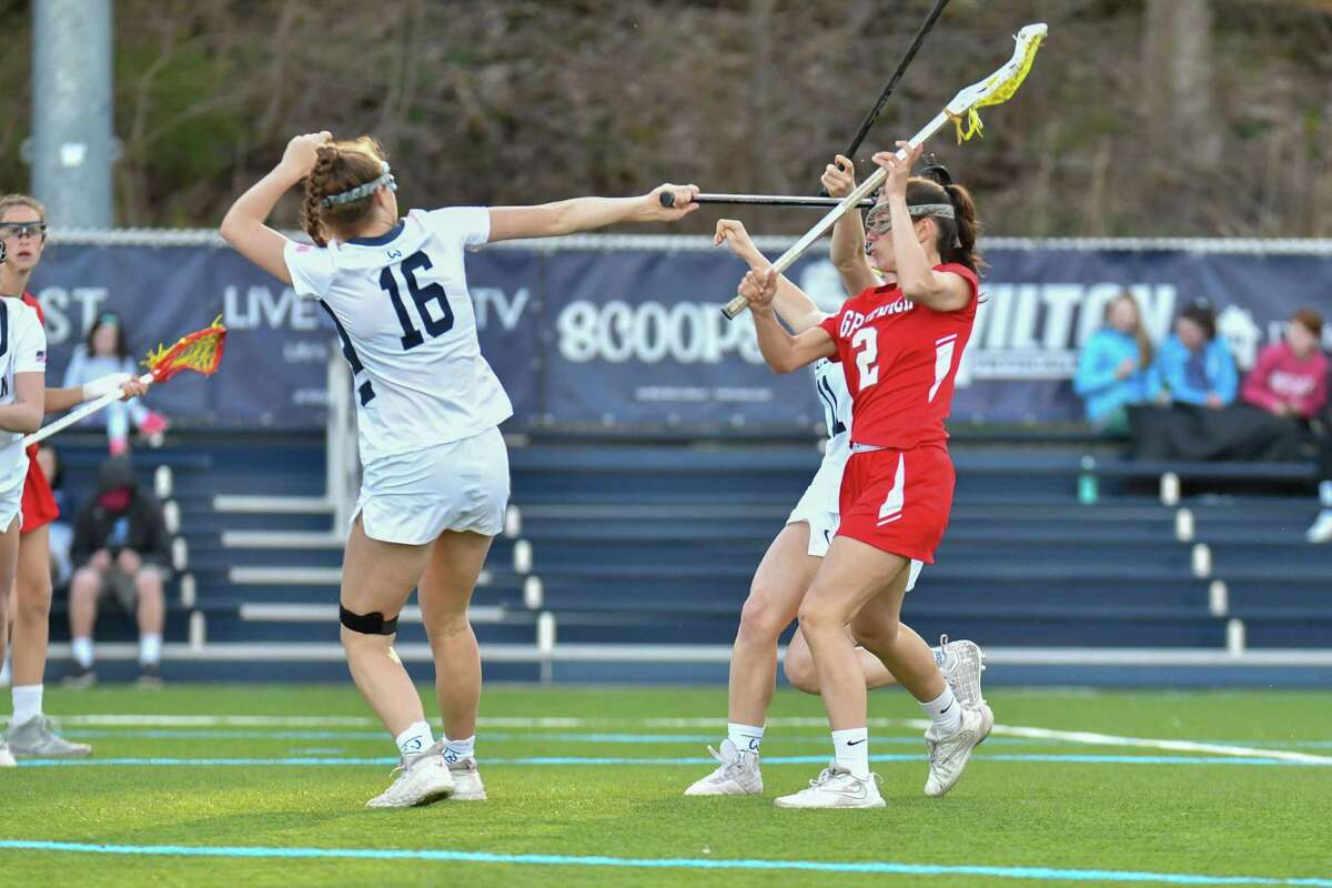 Paige Finneran (2) of the Greenwich Cardinals shoots and scores during a game against the Wilton Warriors on Wednesday April 17, 2019 at Wilton High School, in Wilton, Connecticut.