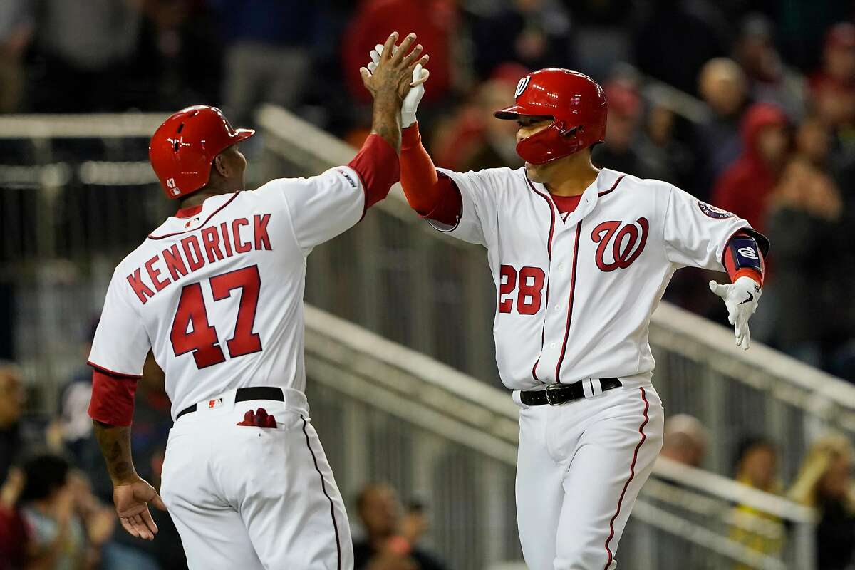 WASHINGTON, DC - APRIL 17: Kurt Suzuki #28 of the Washington Nationals celebrates with Howie Kendrick #47 after hitting a two-run home run in the seventh inning against the San Francisco Giants at Nationals Park on April 17, 2019 in Washington, DC. (Photo by Patrick McDermott/Getty Images)
