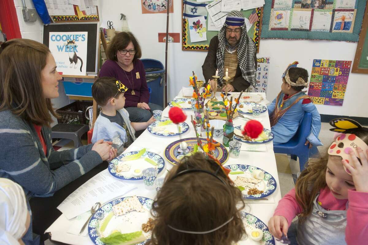 Rabbi Colin Broady, dressed as Moses, leads a Seder meal for nursery school students at Congregation B'nai Torah, in Trumbull, Conn. April 8, 2019.