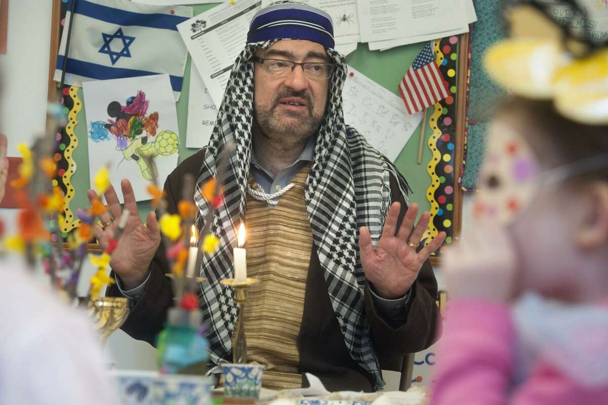 Rabbi Colin Broady, dressed as Moses, leads a Seder meal for nursery school students at Congregation B'nai Torah, in Trumbull, Conn. April 8, 2019.