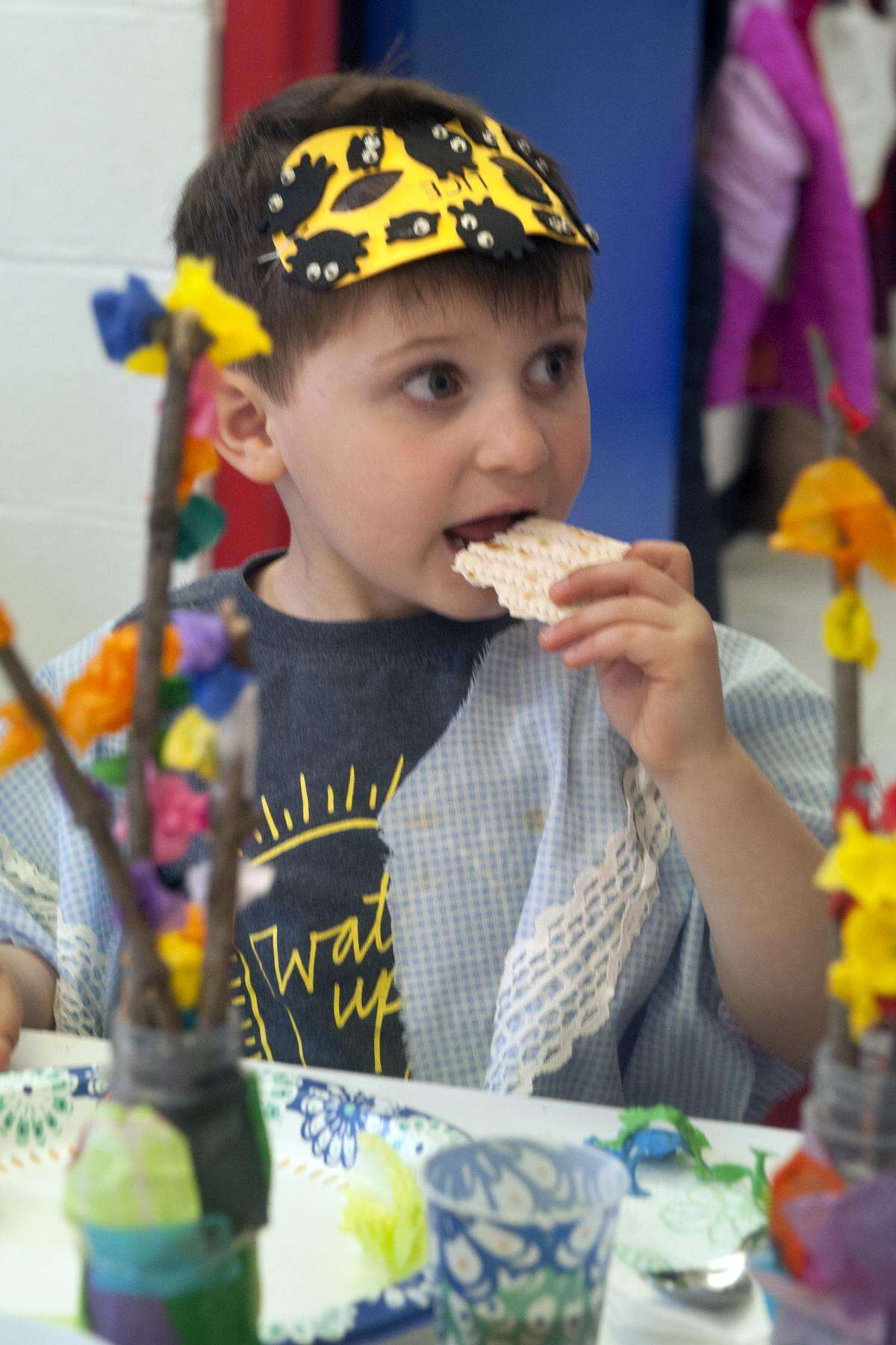 Noah Shufrin samples a piece of matzo during a Seder meal for nursery school students at Congregation B'nai Torah, in Trumbull, on April 8,