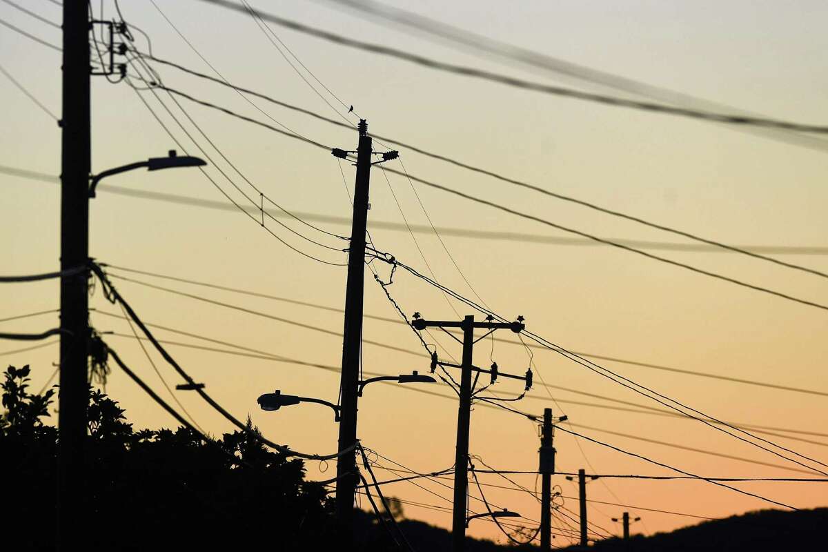 Power transmission lines cross a street in Sonoma, Calif., on Monday, Oct. 15, 2018. Some customers in the region remain without power after PG&E cut electric service in hopes of preventing fires amid red flag fire warnings.