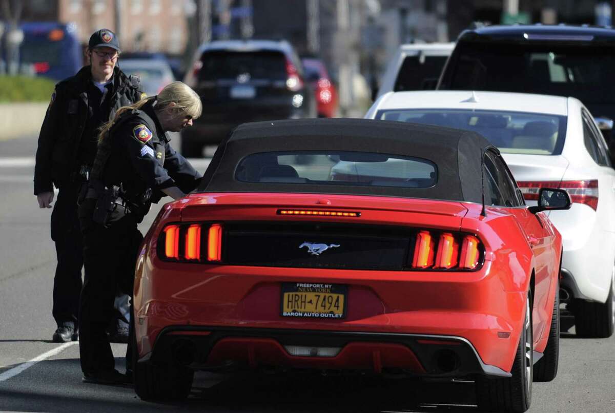 Sgt. Jennifer Pinto of the Stamford Police Department conducts a traffic stop on Washington Blvd. with police office Thomas Drain Tuesday, April 16, 2019 in Stamford, Connecticut. Pinto and a team of city traffic officers were citing distracted drivers as part of a national U Drive, U Text, U Pay, high-visibility enforcement effort. April is National Distracted Driving Awareness Month.