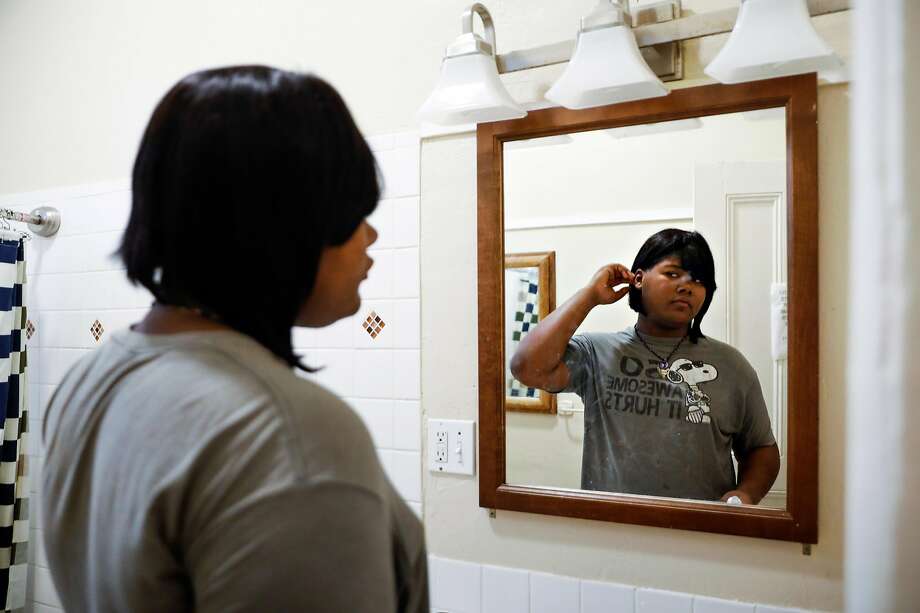 A trans woman named Kat Blackburn looks in the mirror after brushing her teeth at her home in San Francisco, California, on Wednesday, April 17, 2019. Kat lives in one of the first shelter-transitional housing programs in the United States for transgender youths in San Francisco. Photo: Gabrielle Lurie / The Chronicle