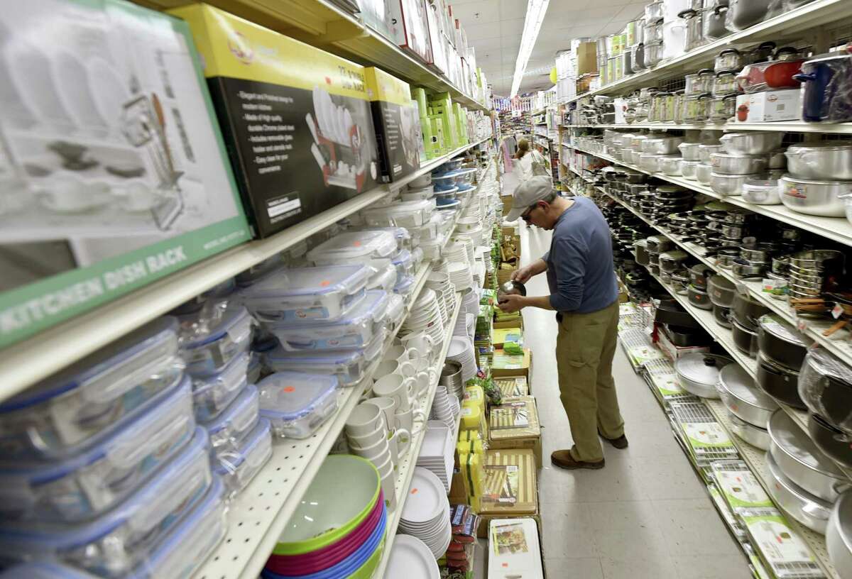 Robert Randy of Orange searches for kitchen items Wednesday at the new Dollar & Dream store in West Haven.
