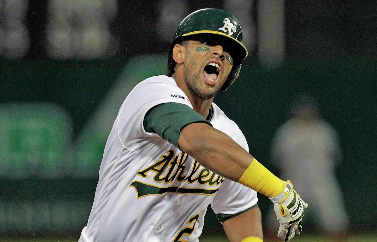 Khris Davis (2) reacts as he rounds the base following his solo homerun in the second inning as the Oakland Athletics played the Boston Red Sox at the Coliseum in Oakland, Calif., on Monday, April 1, 2019.