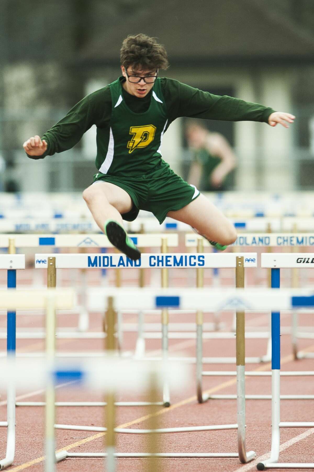 Dow's Mike Rettelle competes in a hurdle event during the Graves/Swayze Relays on Thursday, April 18, 2019 at Midland Community Stadium. (Katy Kildee/kkildee@mdn.net)