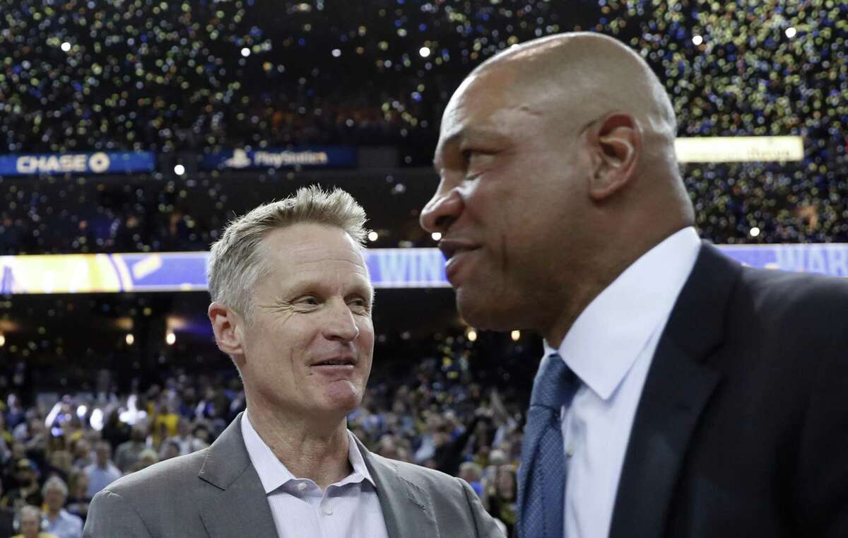 Golden State Warriors' head coach Steve Kerr greets Los Angeles Clippers' head coach Doc Rivers after Warriors' 131-104 win in NBA game at Oracle Arena in Oakland, Calif., on Sunday, April 7, 2019.