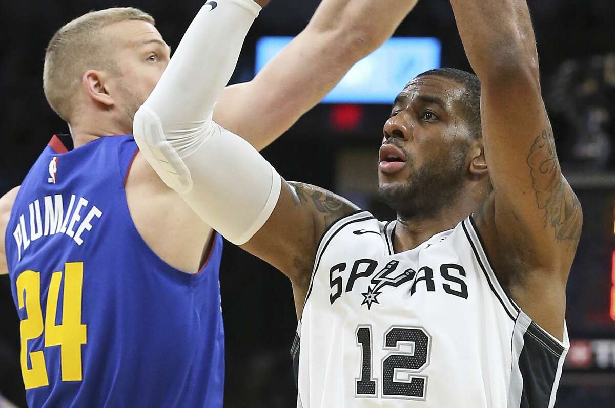 LaMarcus Aldridge gets off a three point try past Mason Plumlee to beat the buzzer in the first half as the Spurs host the Nuggets in game 3 of the first round on Western Conference playoffs at the AT&T Center on April 18, 2019.