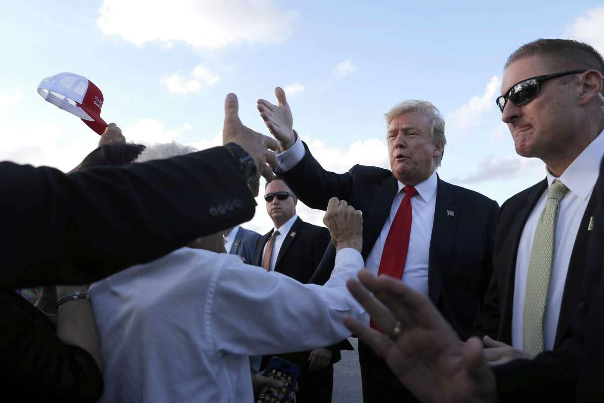 President Donald Trump greets people at Palm Beach International Airport, Thursday, April 18, 2019, in West Palm Beach, Fla. Trump is spending the Easter weekend as his Mar-a-Lago estate. (AP Photo/Pablo Martinez Monsivais)