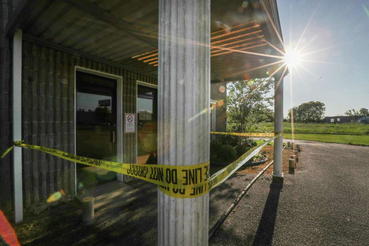 Yellow police tape hangs around the outside of Arcola’s City Hall building Tuesday, April 9, 2019, in Arcola.