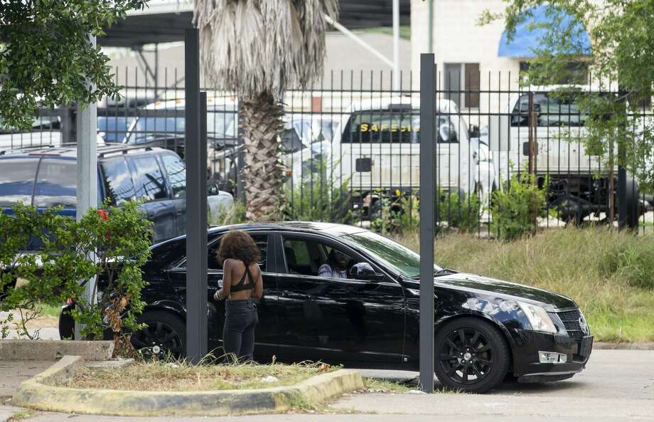 prostitute next to a car