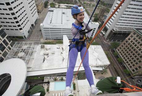 Faith Malton is excited to propel down from the 21st floor of Hotel Alessandra on Saturday, April 13, 2019, in Houston. The 22-year-old University of Houston student was born with one arm and participated in the annual fundraiser to raise money for Special Olympics.