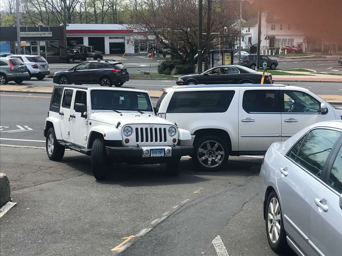 Police investigate a parking accident next to the Bull's Head United State's Post Office where a woman was run over by her own large SUV early Friday afternoon.