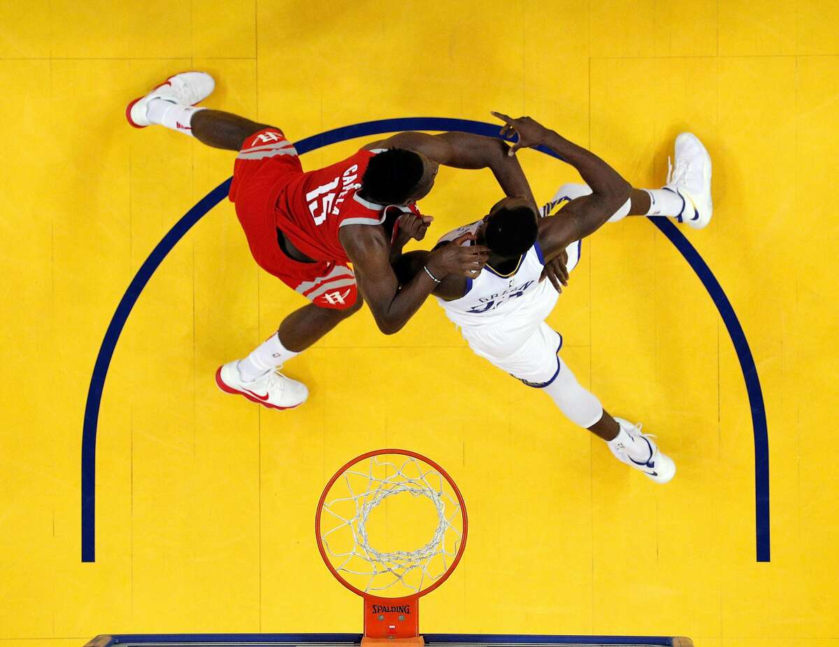Draymond Green (23) and Clint Capela (15) battle for position under the basket in the first half as the Golden State Warriors played the Houston Rockets in Game 6 of the Western Conference Finals at Oracle Arena in Oakland, Calif., on Sunday, May 27, 2018.
