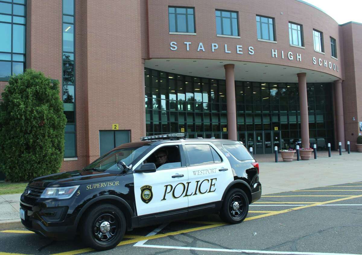 A Westport police car sits outside Staples High School.