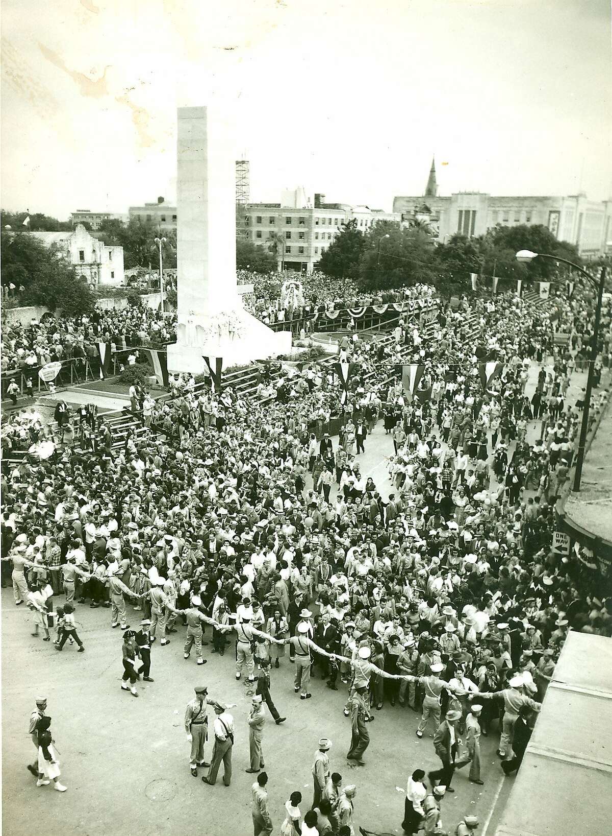 Fiesta 1950 - The parade is over and police engage in crowd control around the Alamo Cenotaph.