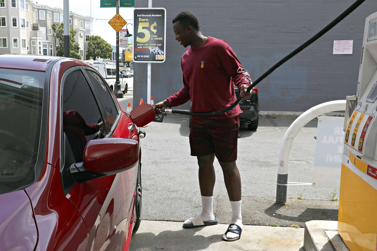 Cal state student and Lyft driver Mathayo Huma from Hayward tops off his gas at the beginning of his shift at a Shell station on 5th St. on Friday, April 19, 2019 in San Francisco, Calif.