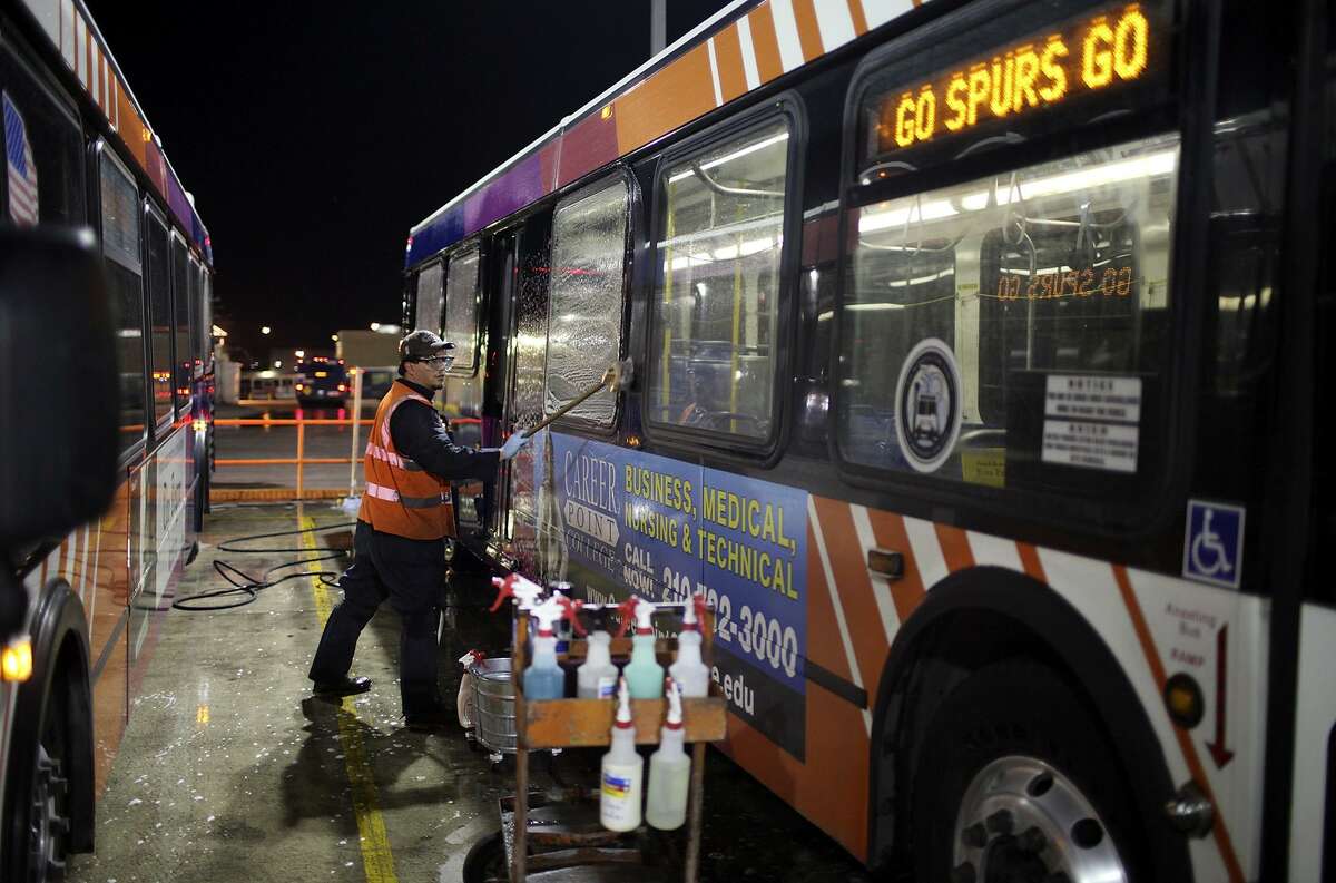 VIA Metropolitan Transit employee Joseph Trevino, 42, scrubs a bus featuring an ad on Feb. 15, 2011, part of an eight hour detailing that happens every six weeks. Metropolitan Transit Authority is considering allowing advertising, possibly similar to that on VIA buses.