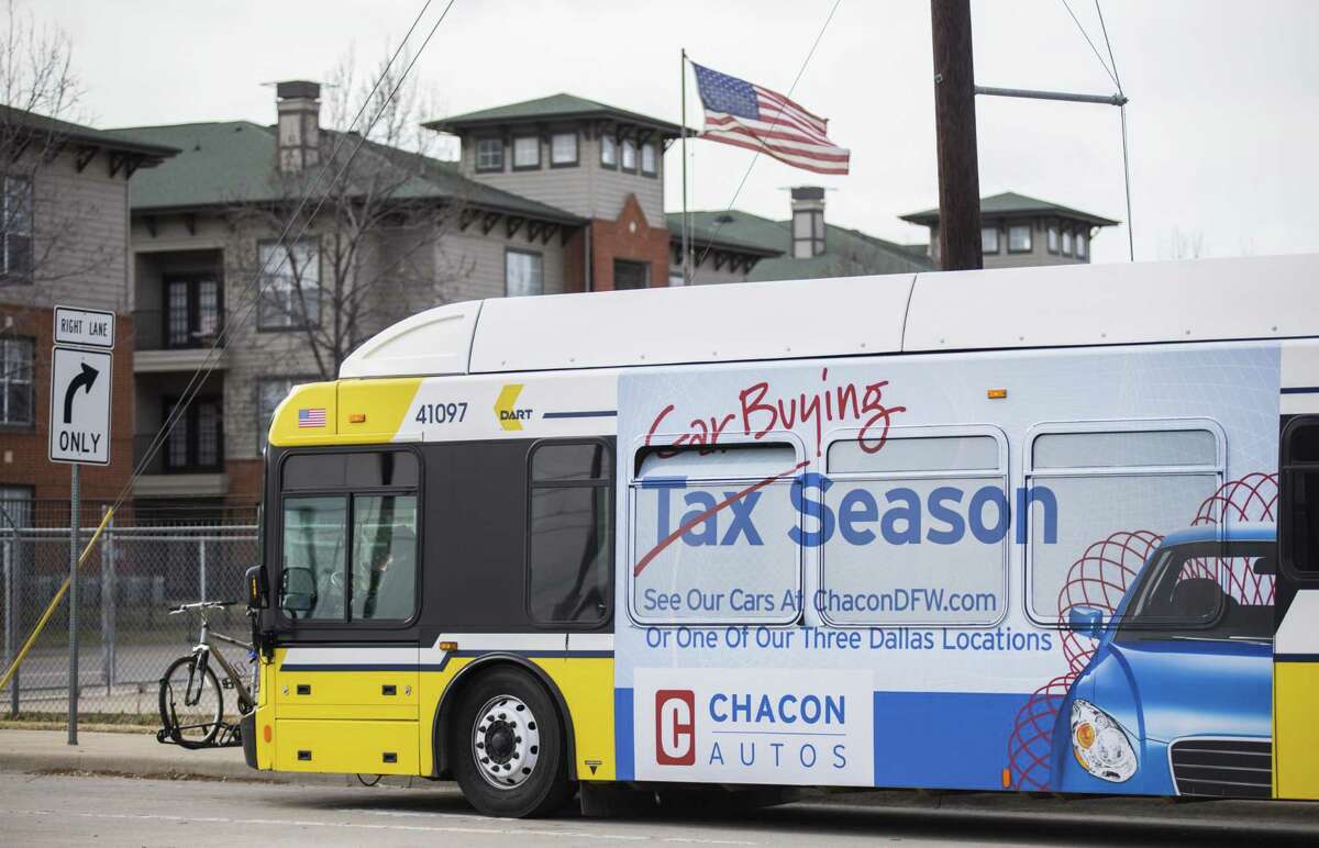 A Dallas Area Rapid Transit bus featuring a large ad on its side waits at a stop in southern Dallas on Feb. 15, 2018. Metropolitan Transit Authority is considering allowing advertising, possibly similar to that on DART buses.