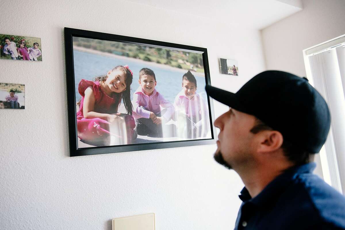 Ramon Wence-Valladolid looks up at pictures of his children in his home in Walnut Creek, Calif, on Friday, April 19, 2019. Ramon's DUI case and associated fines and fees is one of the first tests of January appeals court ruling that found it was unconstitutional to force criminal fines upon people who couldn't pay them.