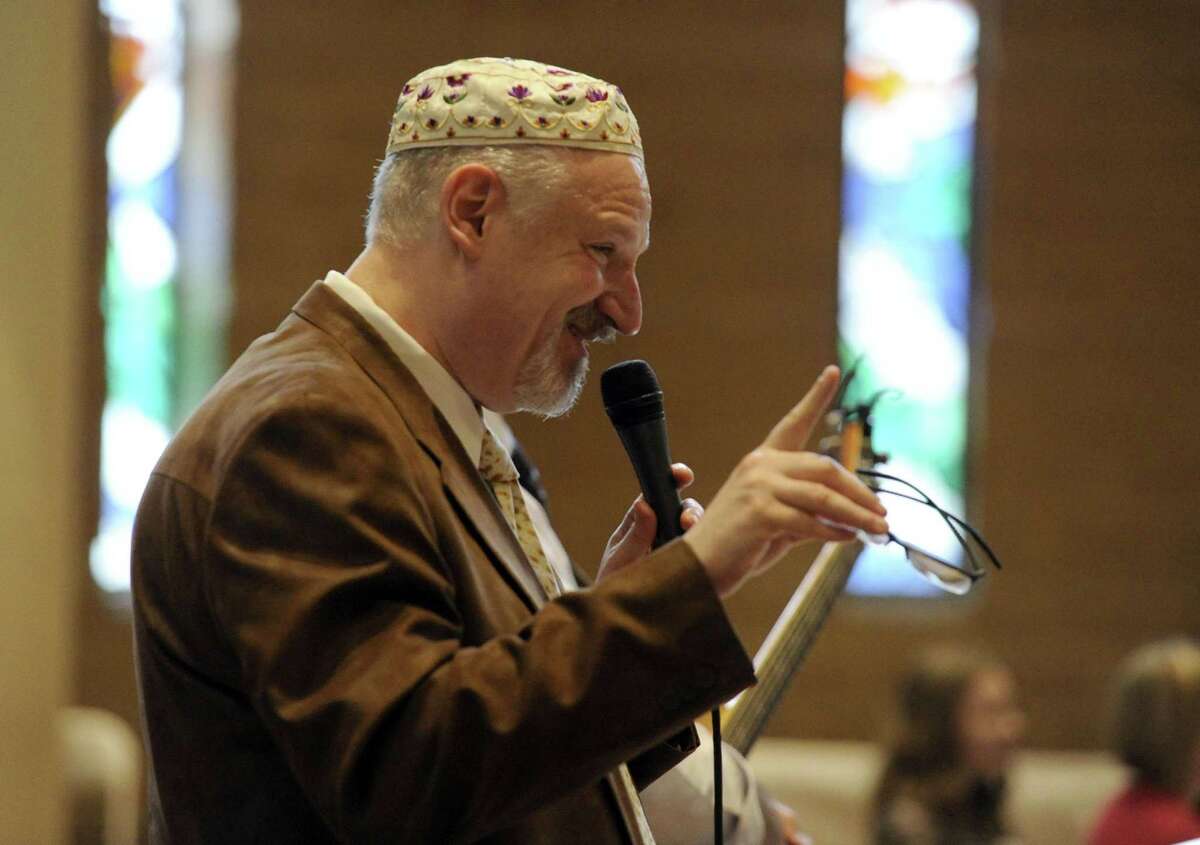 Rabbi Mitchell M. Hurvitz reads a passage during an Interfaith Passover Seder at Temple Sholom on Friday, April 19, 2019 in Greenwich, Connecticut. The Passover Seder is a Jewish ritual feast that marks the beginning of the Jewish holiday of Passover.