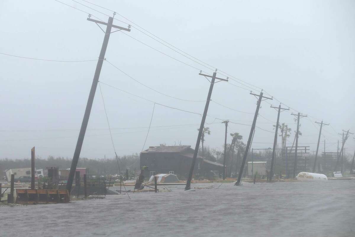Crooked power poles and debris from Hurricane Harvey shown on Saturday, Aug. 26, 2017, in Rockport, Texas.