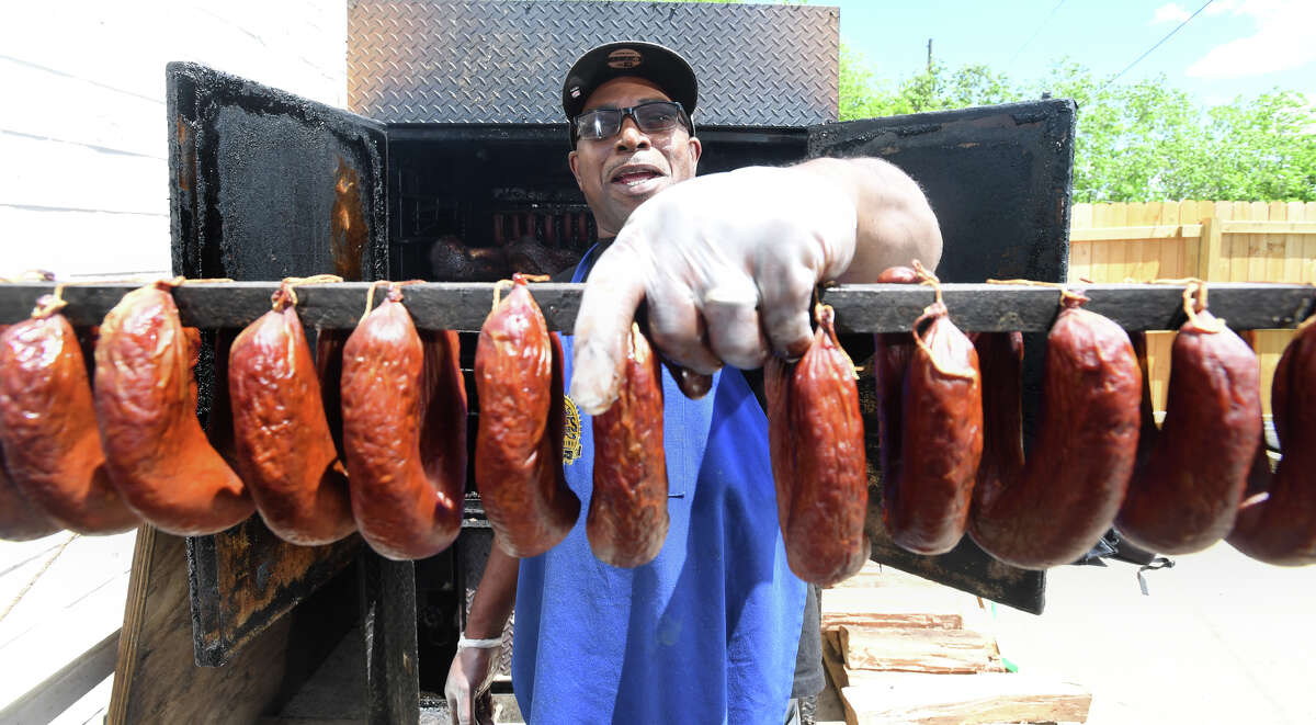 Charles Brewer holds a rack of links at his barbecue restaurant in Beaumont Friday. Brewer's place Charlie's has been recognized by Texas Monthly and is on the magazine's midterm list of best barbecue in Texas. Photo taken Friday, 4/19/19