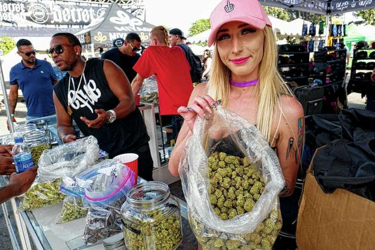 A bud tender offers attendees the latest products of cannabis at the High Times 420 SoCal Cannabis Cup on April 21, 2018, in San Bernardino, California. Businesses inside and outside the multibillion-dollar cannabis industry are using today — April 20, or “420” — to roll out marketing and social media messaging aimed at connecting with marijuana enthusiasts.