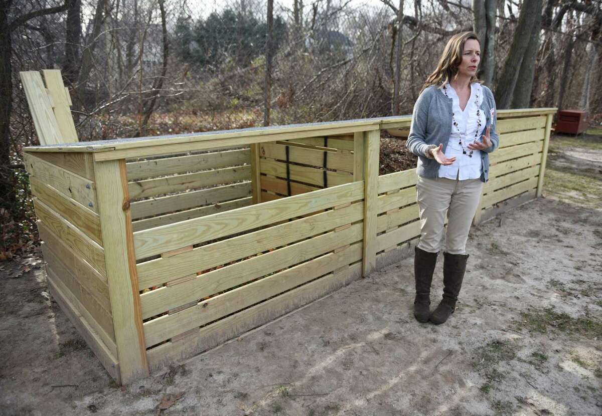 Greenwich Conservation Department Environmental Analyst Aleksandra Moch stands beside the new compost bin behind Riverside School in Greenwich, Conn. Thursday, Jan. 7, 2016. Riverside School began implementing a new composting program this week. Students throw their fruits and vegetables into a separate container at the end of their lunch period and contents are then brought outside into the composting bin behind the school.