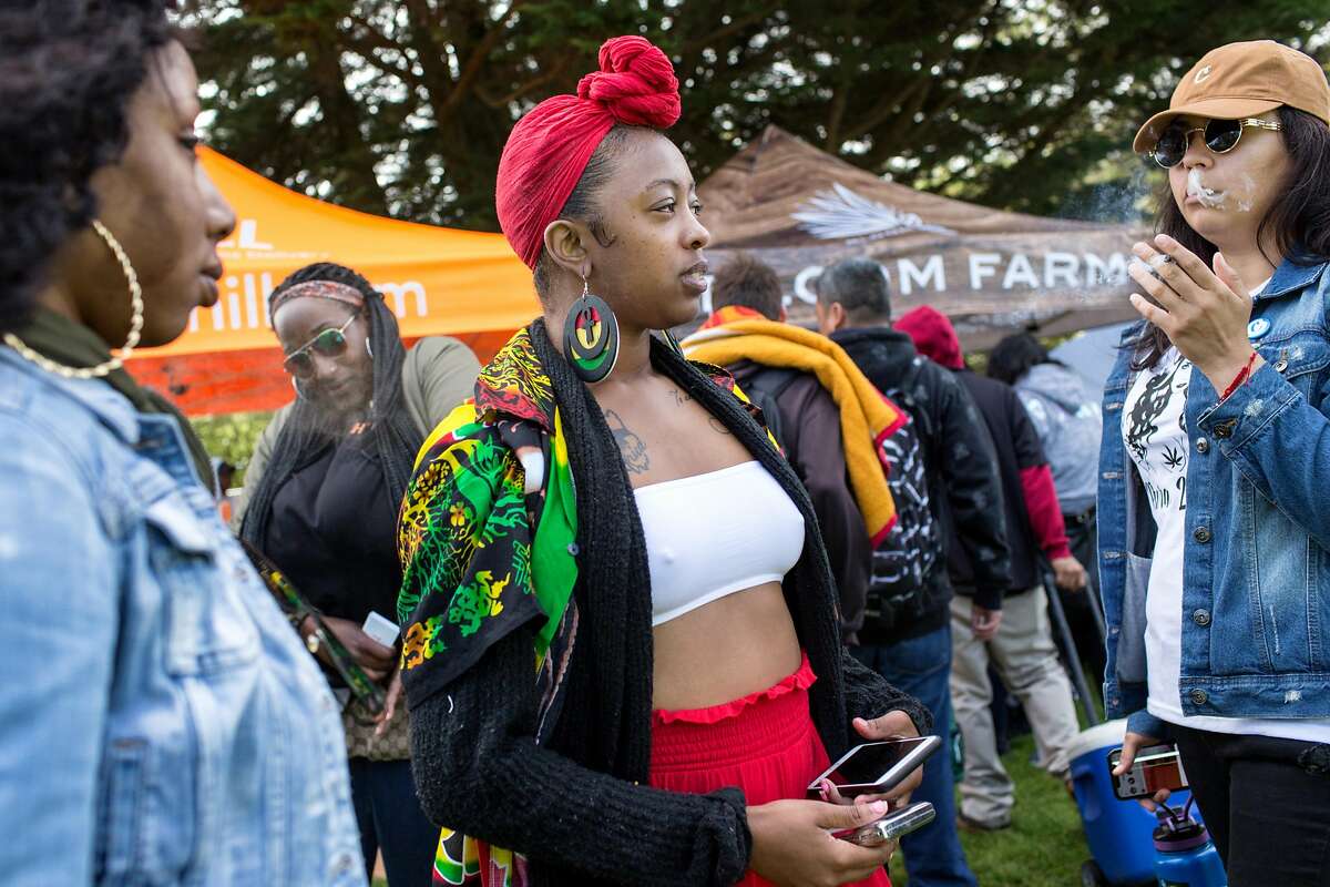 Nikita Frierson, left, Jonnae Penermon, center and Raquel Quintana, share a joint during the annual 420 in the Park pot festival at Hippie Hill in Golden Gate Park. Saturday, April 20, 2019. San Francisco, Calif.