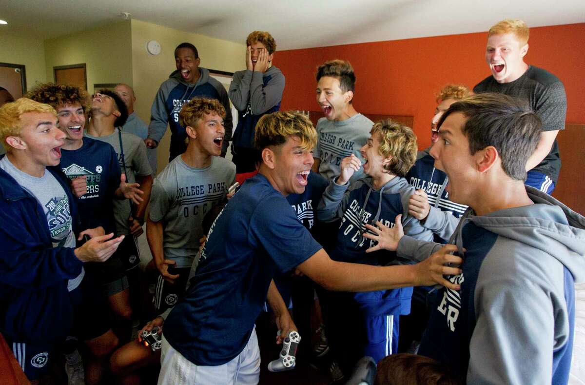 College Park midfielder Jafet Lara, center, reacts among teammates after scoring a goal in a loser-out style FIFA video game tournament in the team’s hotel prior to taking on San Antonio LEE in the Class 6A state semifinals of the UIL State Soccer Championships, Friday, April 19, 2019, in Georgetown. This image was a part of Jason Fochtman’s winning entry for Texas APME Star Photojournalist of the Year.
