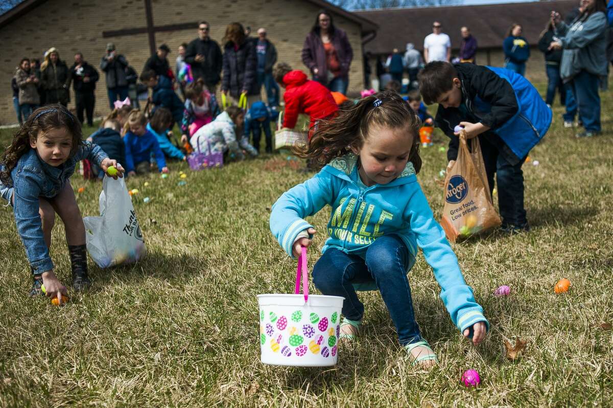 Beverleigh Bentley of Saginaw County, 6, reaches down for an egg during an Easter egg hunt on Saturday, April 20, 2019 at Faith Wesleyan Church. (Katy Kildee/kkildee@mdn.net)