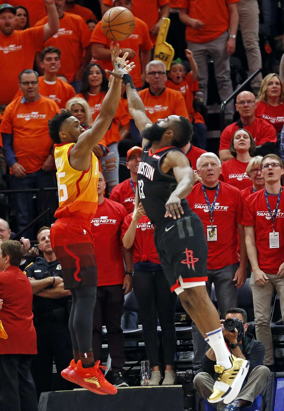 Houston Rockets guard James Harden (13) fouls Utah Jazz guard Donovan Mitchell, left, as he shoots a 3-pointer in the first half during an NBA basketball game Saturday, April 20, 2019, in Salt Lake City. (AP Photo/Rick Bowmer)