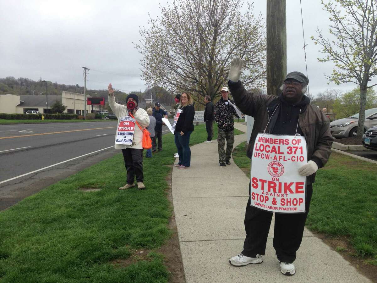 About 15 employees picketed outside the Stop & Shop on Newtown Road in Danbury on the 11th day of the strike against the company. Jimmy Wilson, who has worked at the store for 2 1/2 years, is on the right. Joey Weston, who has worked for the company since 1992, is on the left.