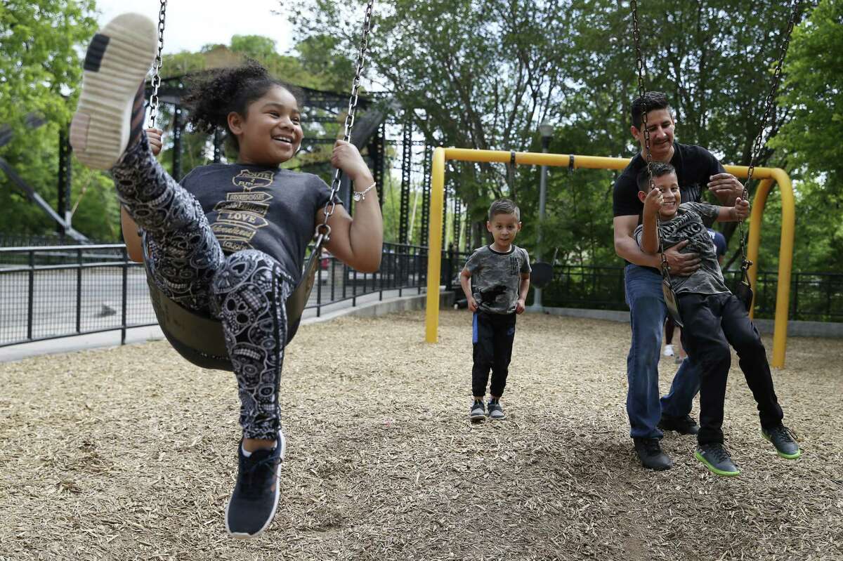 Stella Aguilar, 9, left, joins the Rios family for fun at the swings at Brackenridge Park, Sunday, April 21, 2019. With her are from left, Ivan Rios, 5, Horacio Rios and Diego Rios 10. Thousands gathered at Brackenridge and other city parks in celebration of Easter Sunday.