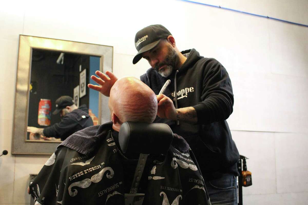 Owner Ralph Bonadio gives a customers a hot towel shave.